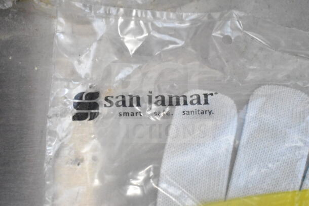 San Jamar packaging with gloves visible through clear plastic. Text reads "smart. safe. sanitary."
