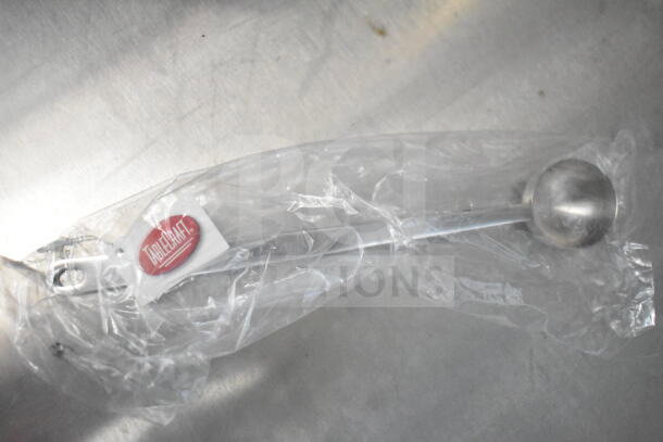 TableCraft ladle sealed in plastic, featuring a stainless steel ladle with a visible brand tag inside the packaging.