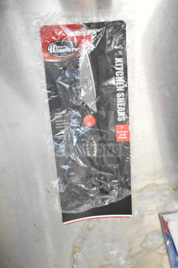 Packaged Winware kitchen shears with ergonomic handles and stainless steel blades, suitable for various kitchen tasks.