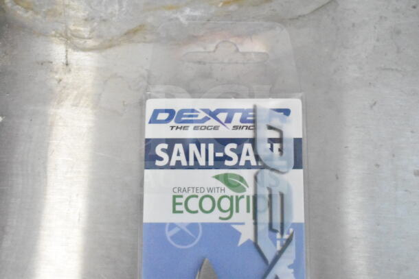 Packaging of Dexter "Sani-Safe" with EcoGrip, visible label on metal surface.