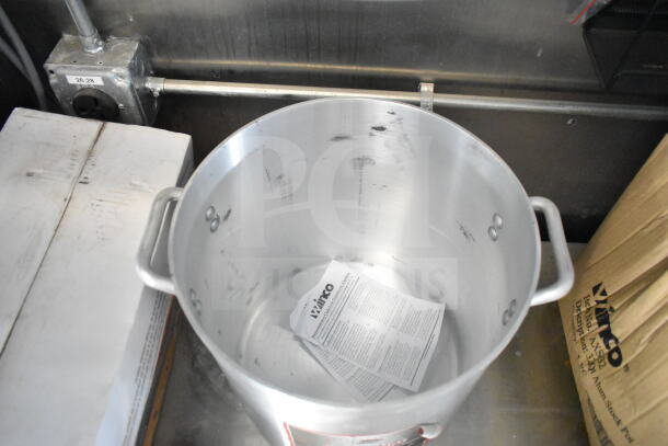 Stainless steel cookware inside 2021 Rock Solid Cargo food trailer with grease hood, fire suppression system, and refrigeration.