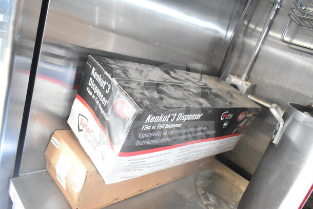 Rock Solid Cargo 8.5'x24' food trailer interior with Kenkut 3 Dispenser box on shelf, displaying kitchen equipment setup.