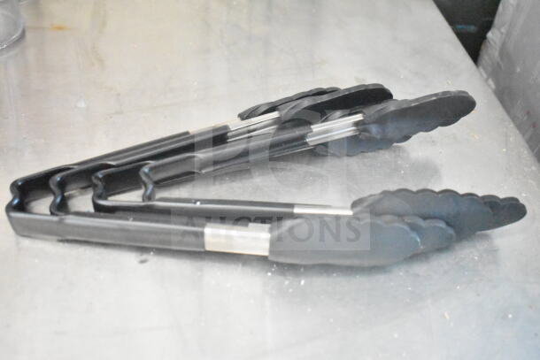 Metal and plastic kitchen tongs on a stainless steel surface.