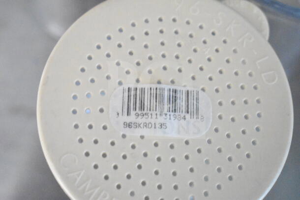 Round white item with small holes and a barcode label reading "9951131984 96SKRD135" visible on its surface.
