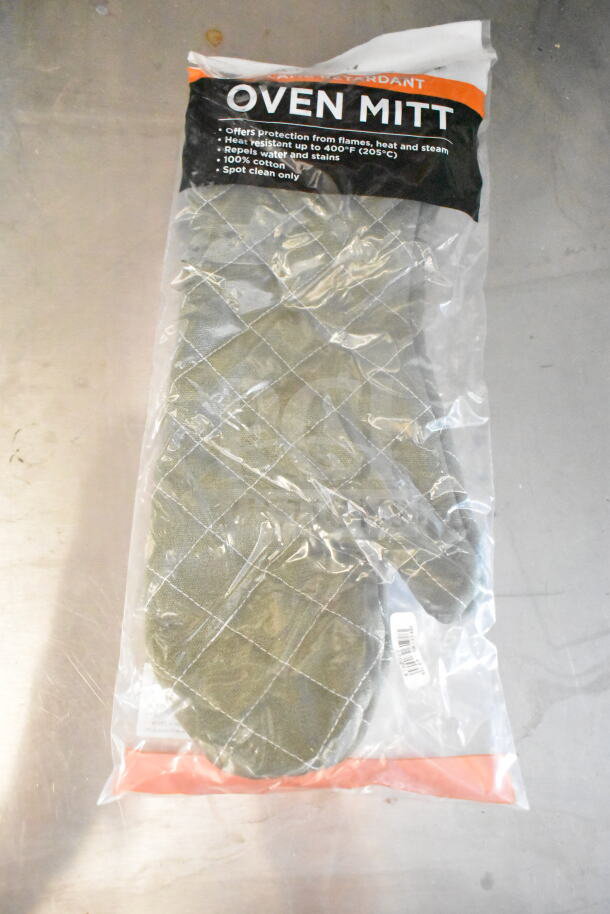 Flame retardant oven mitt in packaging, offers protection up to 400°F, repels water, 100% cotton, spot clean only.