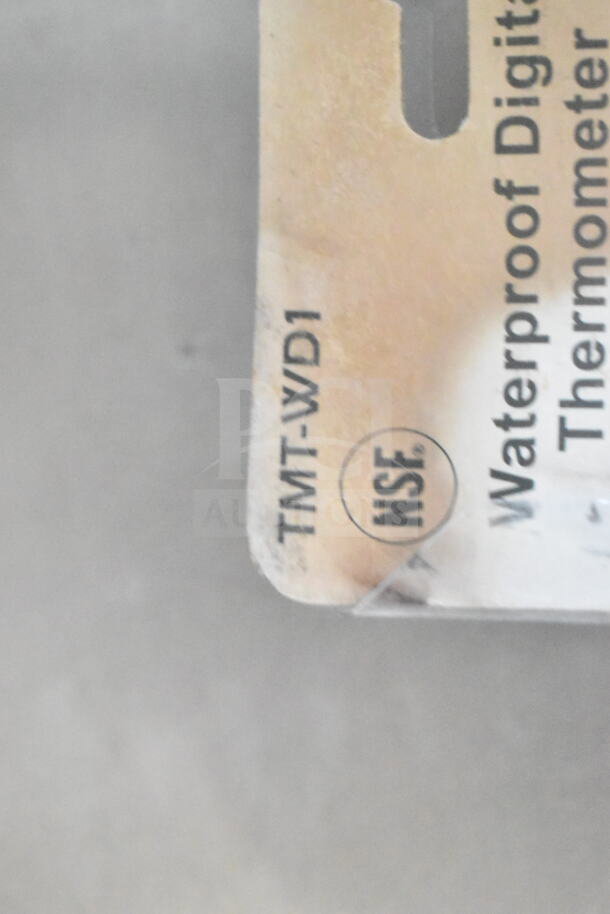 The image shows a tag marked "TMT-WD1" with an NSF logo, part of a waterproof digital thermometer packaging.