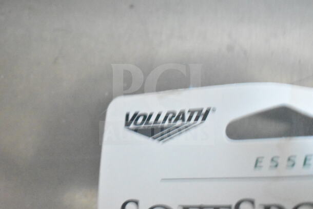 Partial view of a Vollrath label, associated with high-quality kitchen equipment, on a stainless steel background.