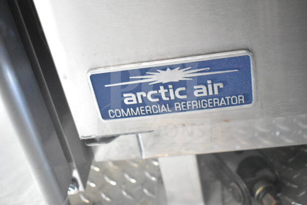 Arctic Air commercial refrigerator label on diamond plate surface inside 2021 Rock Solid Cargo 8.5'x24' food trailer.