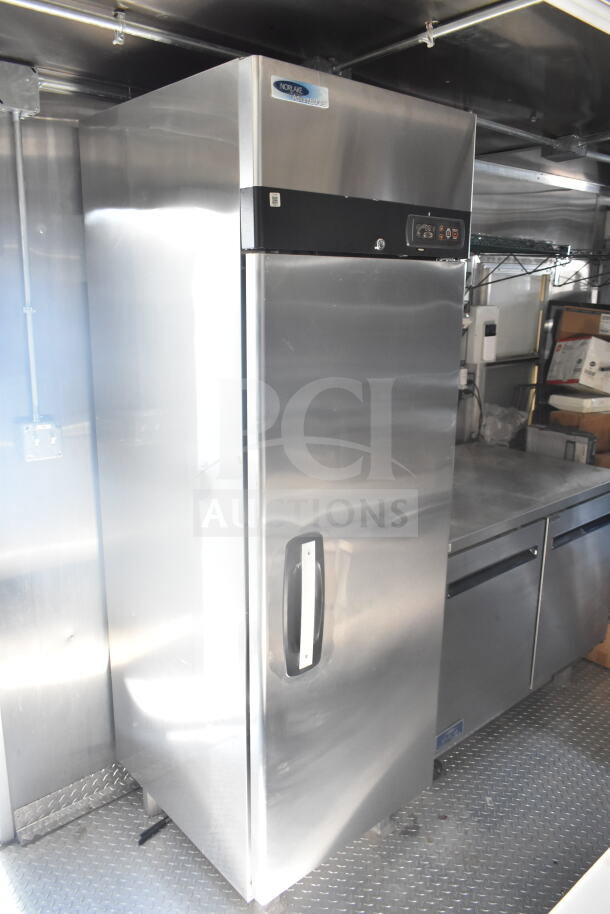 2021 Rock Solid Cargo 8.5'x24' food trailer interior with Norlake refrigeration unit, shiny steel surfaces, good condition.