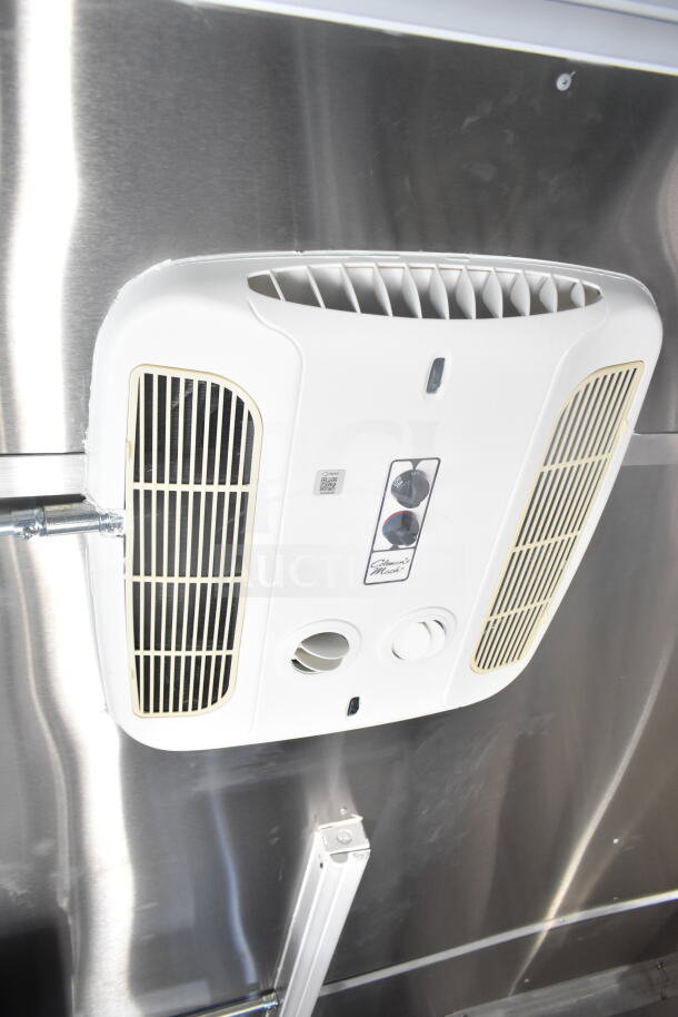 Interior view of 2021 Rock Solid Cargo food trailer, showing mounted heat/AC unit with controls on stainless steel wall.
