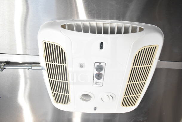 Interior view of a 2021 Rock Solid Cargo food trailer, showing a ceiling-mounted control unit with vents and controls.