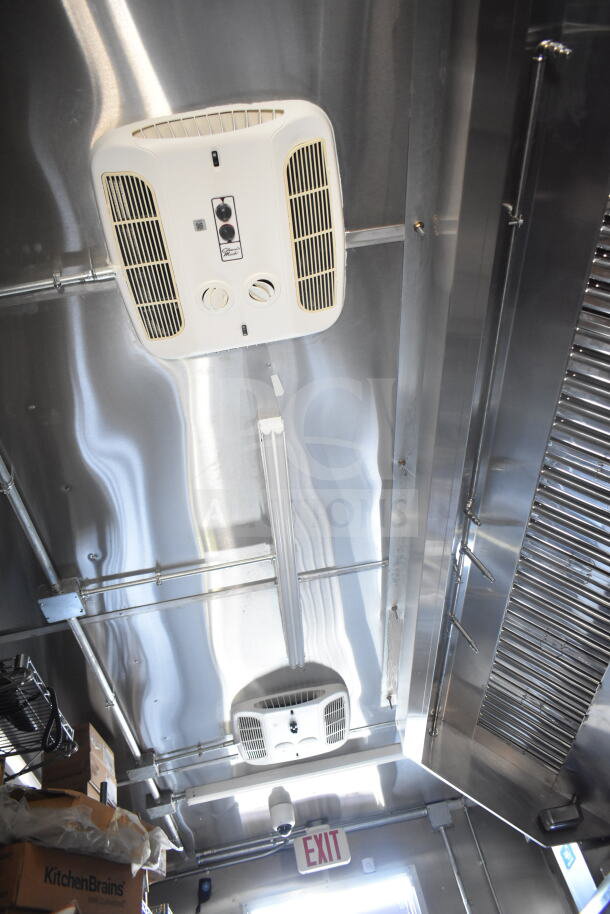 Interior of 2021 Rock Solid Cargo 8.5'x24' food trailer, featuring CaptiveAire grease hood and fire suppression system.