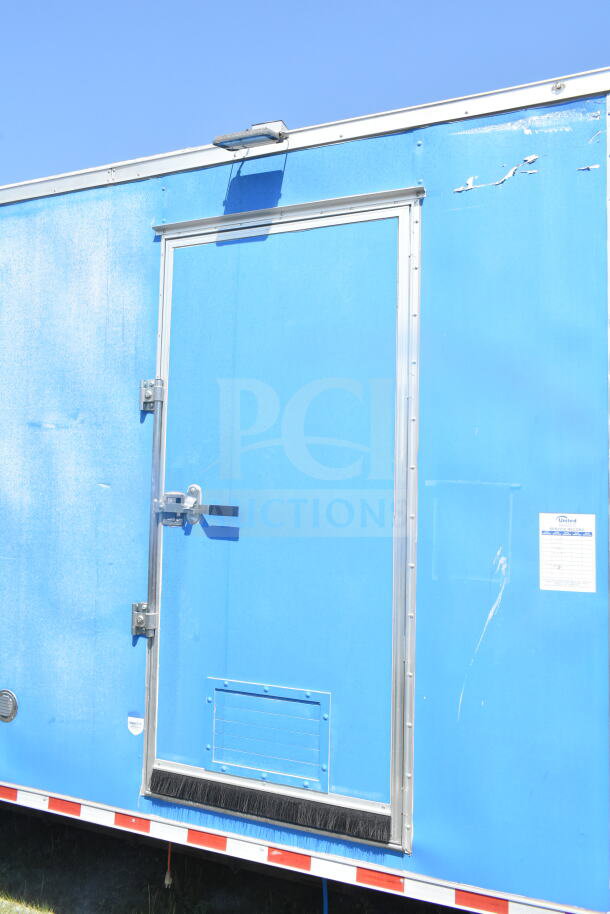 2021 Rock Solid Cargo 8.5'x24' food trailer, blue exterior, visible door handle, minor scratches, United safety inspection sticker.