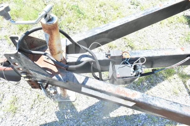 Trailer hitch and electrical connections of a 2021 Rock Solid Cargo 8.5'x24' food trailer, showing rust and wear.