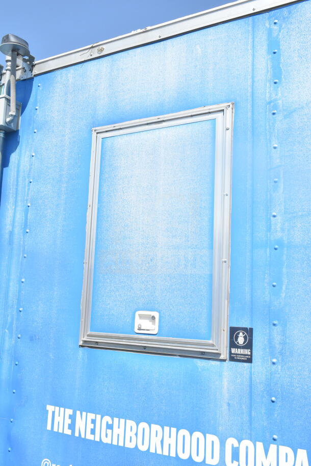 2021 Rock Solid Cargo 8.5'x24' blue food trailer, exterior view, video surveillance warning sticker visible.