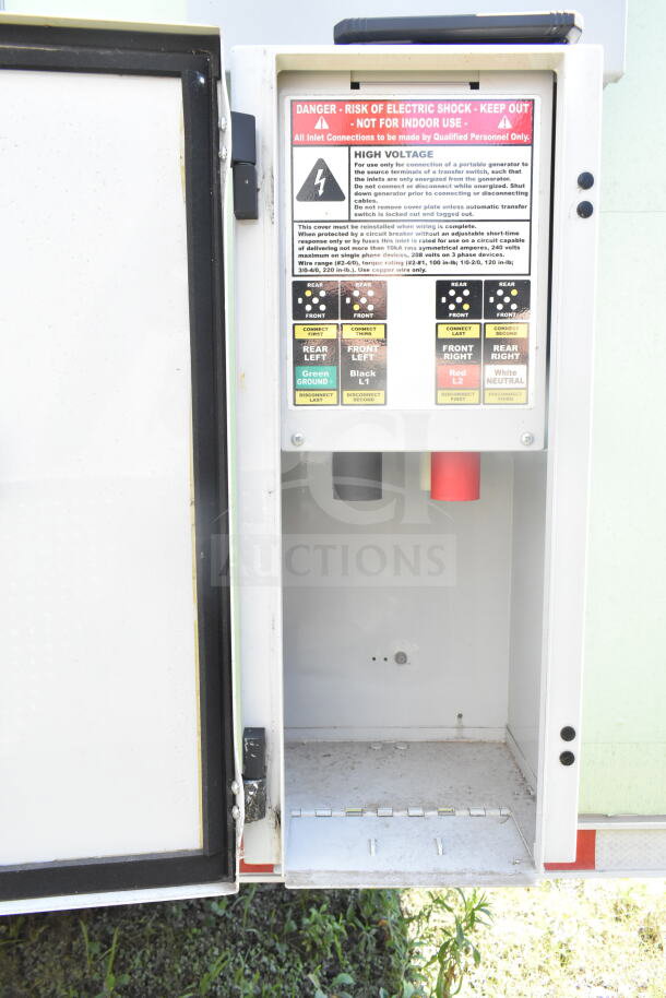 Electric panel inside 2021 Rock Solid Cargo food trailer. High voltage warning label with connection guides.