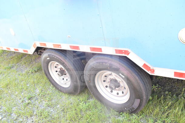 2021 Rock Solid Cargo food trailer, blue exterior, dual wheels, and visible branding on tires; side view.