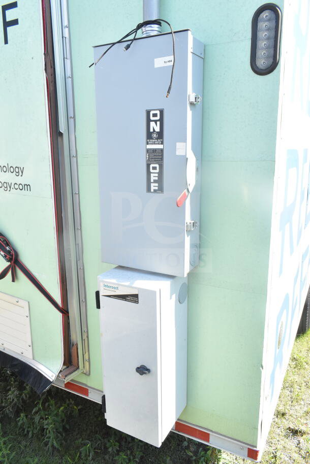 Electrical switch box on a 2021 Rock Solid Cargo 8.5'x24' food trailer exterior, featuring safety labels.