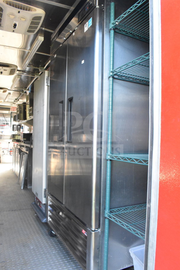 2021 Rock Solid Cargo 8.5'x28' food trailer interior, featuring stainless steel appliances and wire shelving, in clean condition.