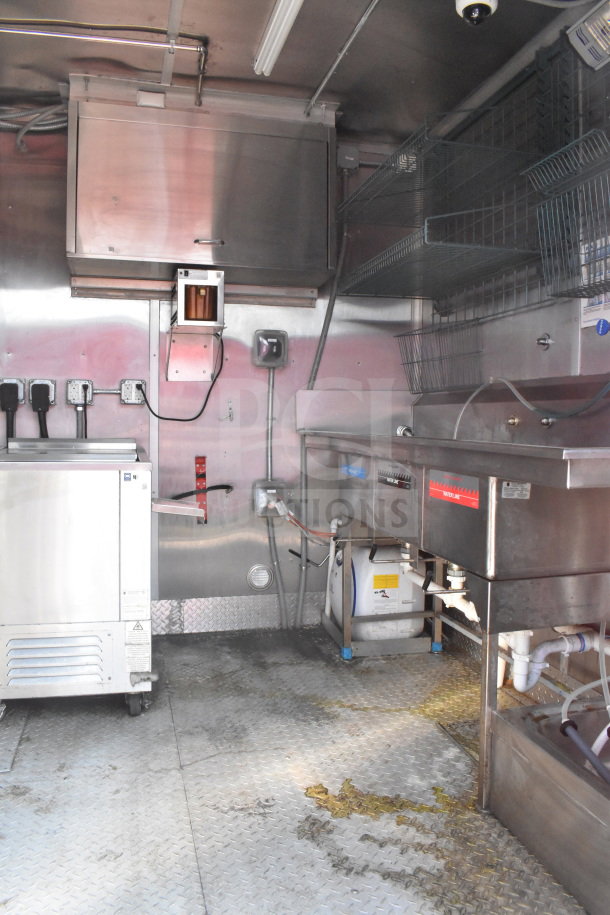 2021 Rock Solid Cargo 8.5'x28' food trailer, equipped with stainless steel fixtures, shelving, and commercial kitchen setup. VIN 7H2BE2831MD037369.