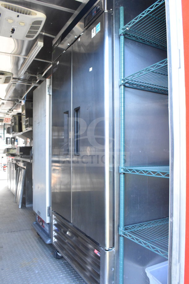 2021 Rock Solid Cargo 8.5'x28' food trailer interior showing stainless steel refrigerator and shelving, in excellent condition.