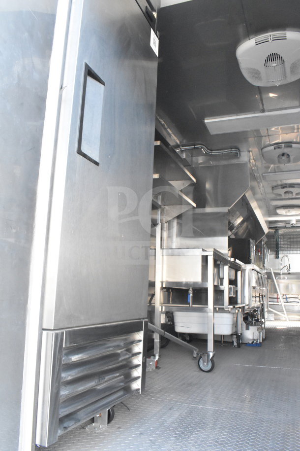2021 Texino 8.5'x28' food trailer interior, featuring industrial kitchen appliances, stainless steel surfaces, and ventilation system.