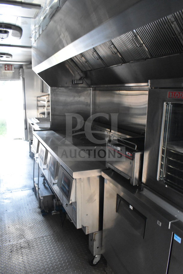 2021 Texino 8.5'x28' food trailer interior, featuring stainless steel kitchen equipment, spacious countertop, and professional oven.