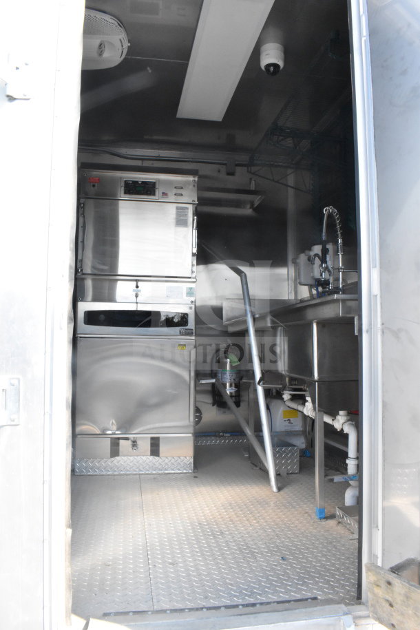 2021 Texino 8.5'x28' food trailer interior. Features stainless steel equipment, sink, and storage. Good condition.