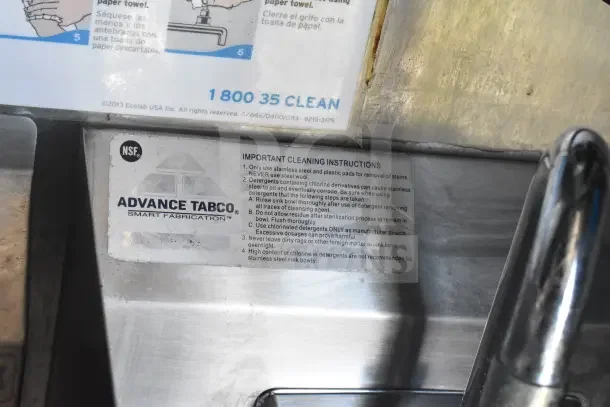 Alt text: "Advance Tabco cleaning instructions on stainless steel surface in 2021 Rock Solid Cargo food trailer."