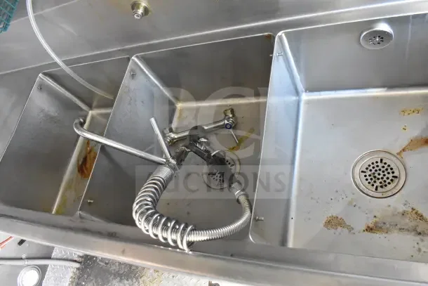 2021 Rock Solid Cargo 8.5'x28' food trailer stainless steel sink with faucet; visible wear marks.