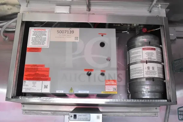 2021 Rock Solid Cargo food trailer CaptiveAire fire suppression system, model tank, safety warnings and labels visible.