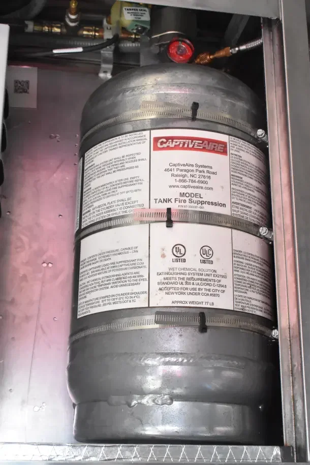 CaptiveAire fire suppression tank in the 2021 Rock Solid Cargo food trailer, labeled for safety compliance.