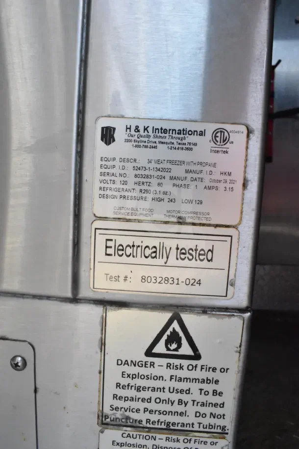 Label on Rock Solid Cargo 2021 food trailer, includes specs for 34" meat freezer with propane, electrically tested.