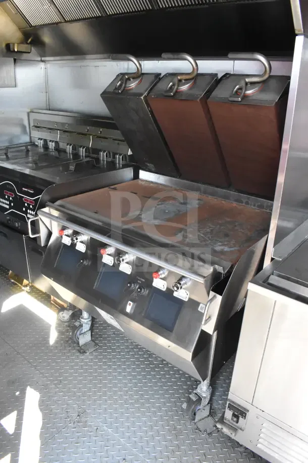 2021 Rock Solid Cargo food trailer interior with Taylor platen grill, CaptiveAire hood, and fire suppression system.