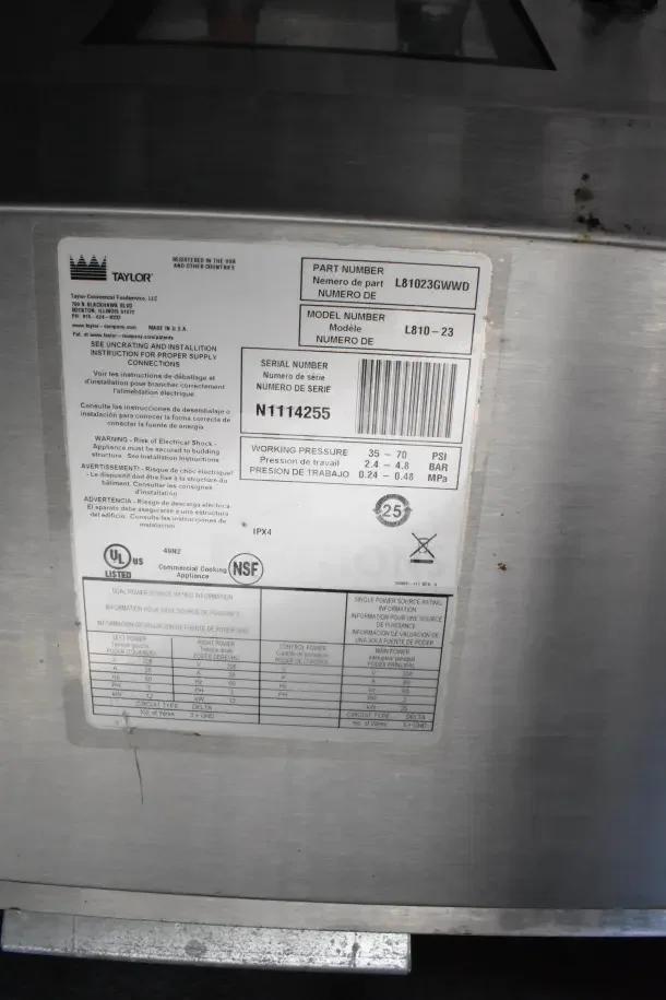 Label on a Taylor Commercial Cooking Appliance with part number L81023GWVD, model number L810-23, and serial number N11I4255. UL and NSF certified.