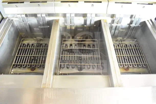 Interior of 2021 Rock Solid Cargo food trailer showing three stainless steel cooking compartments labeled L and R.