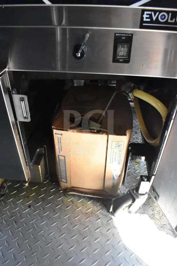 2021 Rock Solid Cargo food trailer interior, showing refrigeration compartment with Evolution label, cardboard box, and wiring.