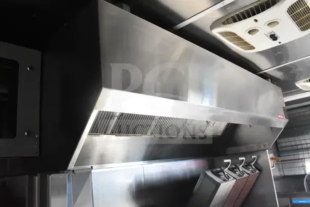 2021 Rock Solid Cargo 8.5'x28' food trailer interior showing CaptiveAire hood, fire suppression system, and refrigeration.