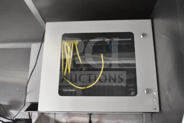 Server rack inside 2021 Rock Solid Cargo food trailer, featuring CyberPower equipment with visible yellow cables.