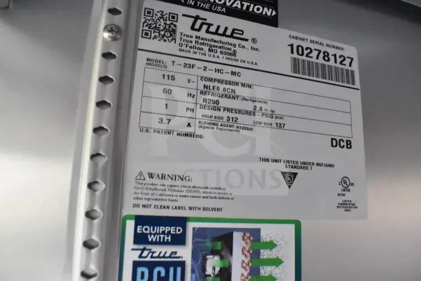 Refrigeration unit label from True Manufacturing, featuring model T-23F-2-HC-MC. Includes warnings and equipment details.