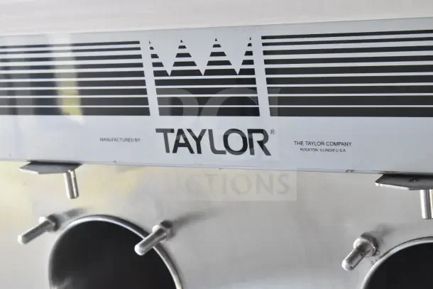 Taylor machine detail inside 2021 Rock Solid Cargo 8.5'x28' food trailer, featuring refrigeration, hood, and grill.