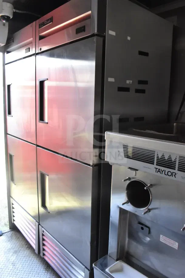 2021 Rock Solid Cargo 8.5'x28' food trailer interior showing CaptiveAire hood, refrigeration suite, Taylor shake machine.