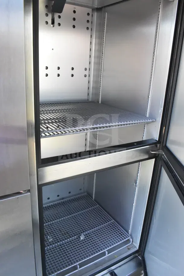 Interior view of a refrigeration unit inside a 2021 Rock Solid Cargo food trailer, showcasing stainless steel shelves and clean condition.