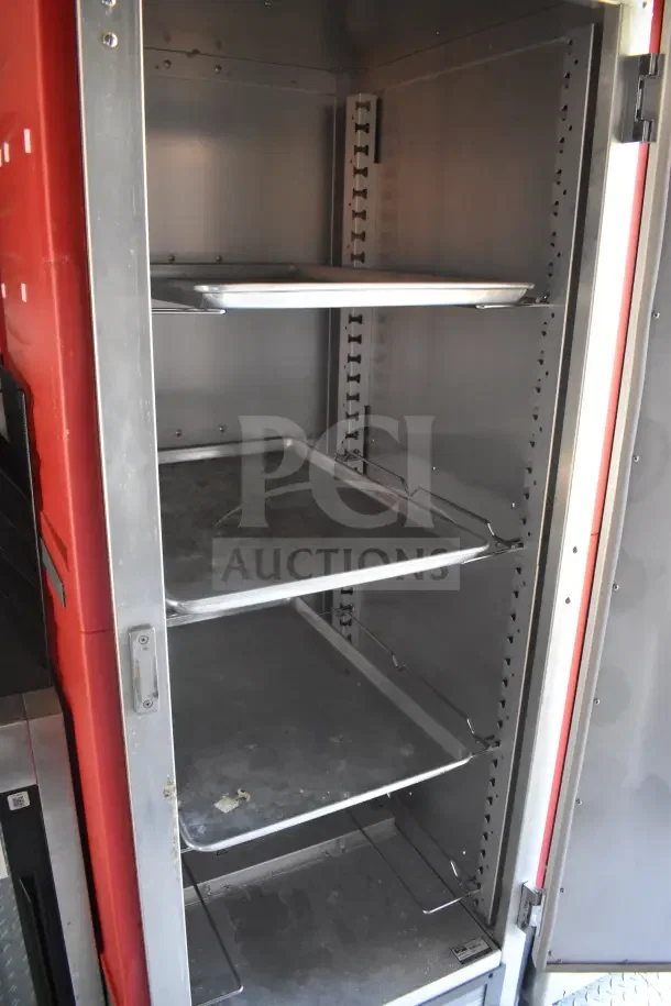 2021 Rock Solid Cargo food trailer interior showing stainless steel shelving, part of refrigeration suite.