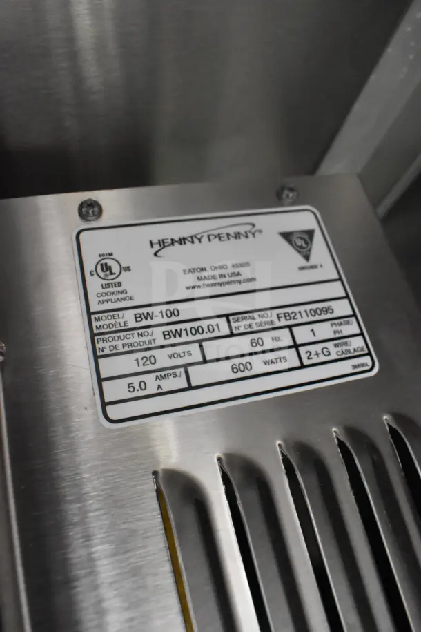 "Henny Penny appliance label on the 2021 Rock Solid Cargo food trailer, featuring model BW-100, voltage 120, and 5.0 amps."