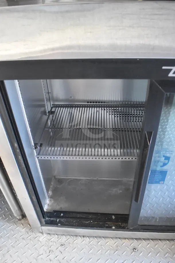 Interior view of the 2021 Rock Solid Cargo 8.5'x28' food trailer refrigeration unit. Clean shelves and durable build.