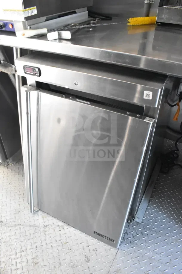 Stainless steel Hoshizaki refrigeration unit in a 2021 Rock Solid Cargo food trailer, featuring a CaptiveAire hood.
