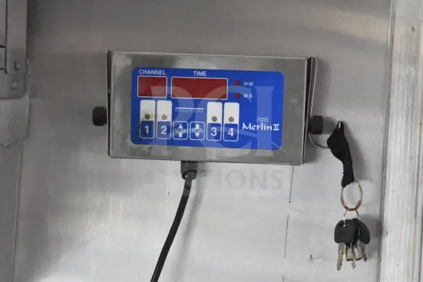Merlin II control panel with timer and channel settings, part of the 2021 Rock Solid Cargo 8.5'x28' food trailer. Keys attached.
