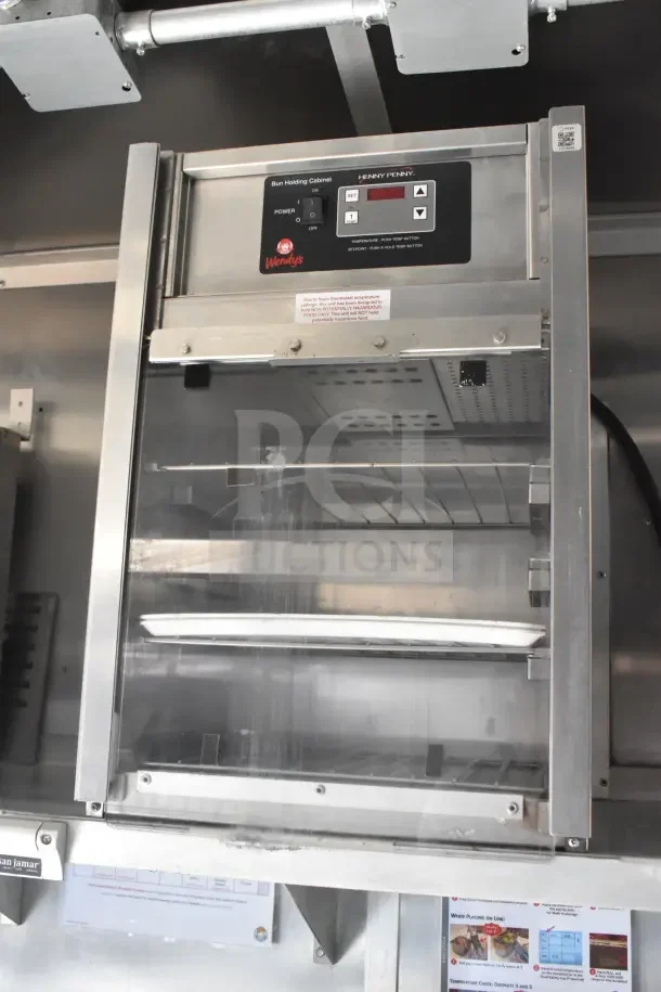 Henny Penny bun holding cabinet in 2021 Rock Solid Cargo food trailer with display panel and shelving.