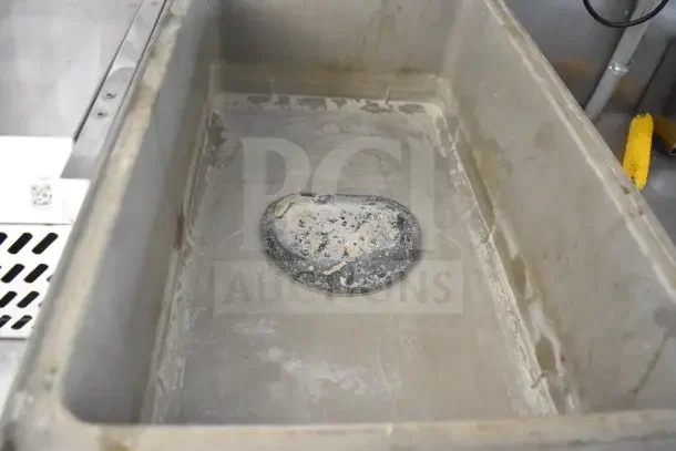Interior of 2021 Rock Solid Cargo 8.5'x28' food trailer showing sink area with wear, part of commercial kitchen setup.